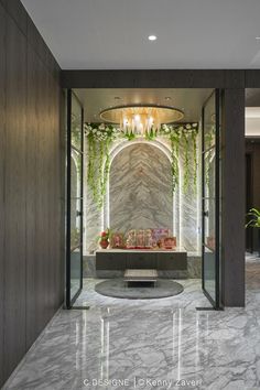 a room with marble walls and flooring that has plants growing on the wall behind it