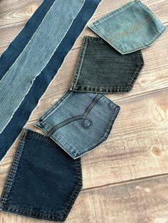 four pairs of jeans laid out on a wooden floor