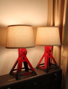 two red lamps sitting on top of a table