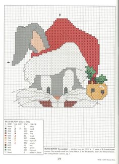 a cross stitch pattern with a cat wearing a santa claus hat and holding a pineapple