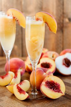 two wine glasses filled with peaches and ice cream