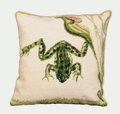 an embroidered frog pillow on a white background