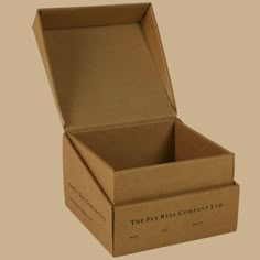 an open box with the lid closed on a beige background, showing the inside of it