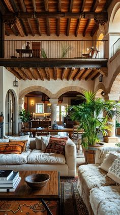 a living room filled with lots of furniture next to a fire place and staircases