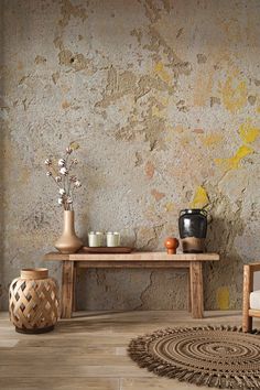 a room with a table, chair and vases on the floor next to it