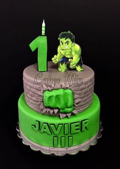 the hulk cake is decorated with green frosting and has a candle on top that reads 1