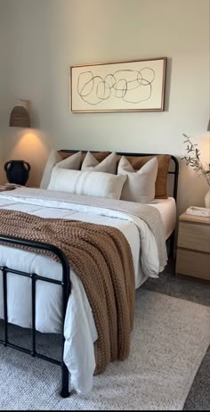 a bed with white sheets and pillows in a bedroom