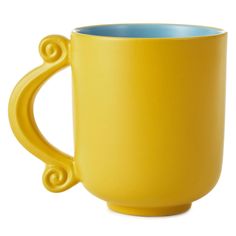 a yellow coffee cup with swirly handles