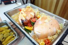 two trays filled with food on top of a table