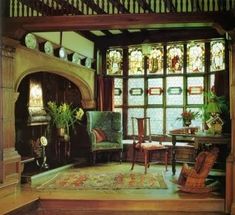 an ornate living room with wood paneling and stained glass windows