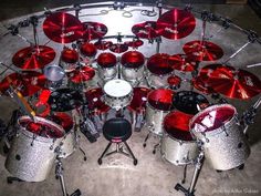 a drum set is shown with red lights on the drums and pedals in front of it