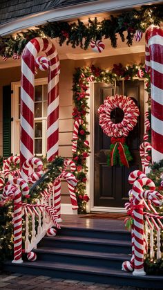 christmas decorations and candy canes on the front steps of a house with wreaths