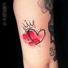 a woman's leg with a tattoo on it and a heart in the middle