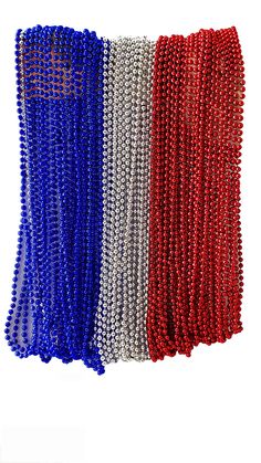 three different colors of beads on a white background and one is red, the other is blue