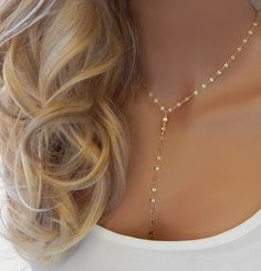 "GOLD LARIAT NECKLACE CHOKER This gold or silver drop necklace features dainty shiny discs that catch the light and is very sparkly. The model in photo #1 is wearing 17\" with the small disc chain. IT'S IN THE DETAILS ✦ 14K Gold Filled or Sterling Silver ✦ Chain Drops of 4\" and 5\" ✦ Large or small discs (See photo #4) ✦ Necklace is shown at 17\" in photo #3 For matching earrings, click here: https://www.etsy.com/listing/590775763 ✦ For Layered Lariat, as shown in photo #5, click here: https:// Luxury Dainty Lariat Necklace For Gift, Adjustable Y-shape Clavicle Chain Drop Necklace, Clavicle Chain Y-shape Drop Necklace, Minimalist Gold Lariat Body Chain, Minimalist Adjustable Lariat Body Chain, Minimalist Delicate Lariat Body Chain, Adjustable Y-shape Lariat Necklace, Silver Lariat Layered Necklace, Bohemian Lariat Necklace With Clavicle Chain For Parties