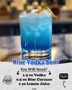 a blue cocktail with ice and lemon on the side, sitting on a table in front of a sign that says blue vodka sour you will need 1 - 5ozer