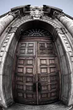 an old building with two large wooden doors