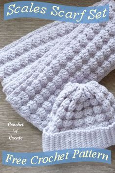 a crocheted hat and booties are sitting on a wooden surface with the words scales scarf set written below it