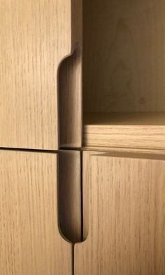 a close up of a wooden cabinet door with a handle on the bottom and side