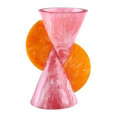 an orange and pink vase sitting next to each other