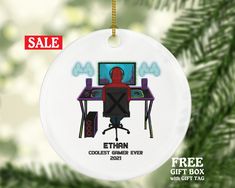 a christmas ornament with an image of a person sitting at a computer desk