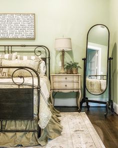 a bedroom with a bed, dresser and mirror