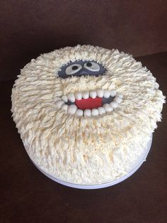 a cake with white frosting and a monster face