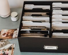 an open file cabinet filled with files on a table