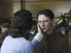 a man in uniform talking to another person