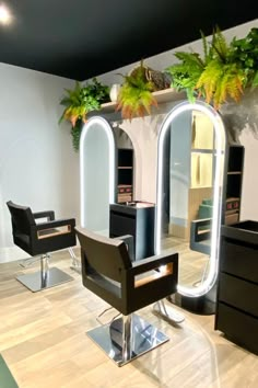 a hair salon with chairs, mirrors and plants