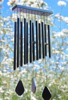 a wind chime hanging from the side of a tree