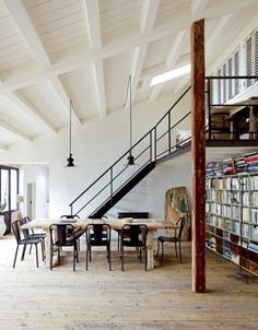 an open floor plan with stairs leading to the upper level and bookshelves on either side