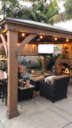 an outdoor patio covered with furniture and lights