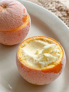 two peeled oranges on a white plate