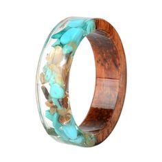 a wooden ring with turquoise stones in it