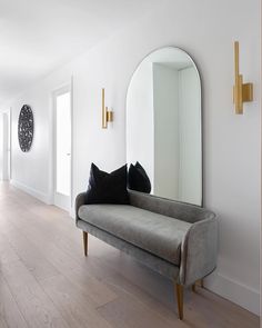 a living room filled with furniture and a large mirror