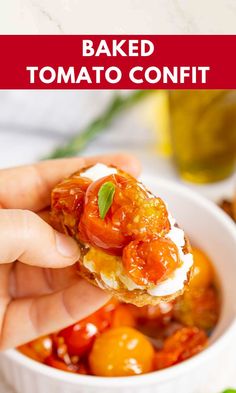 someone is holding up a piece of bread with tomatoes in the background and text overlay that reads baked tomato confit