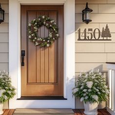 a front door with a wreath and two potted plants