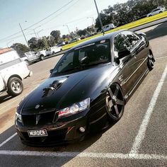 a black sports car parked in a parking lot