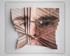 a collage of folded papers with a man's face and glasses on it