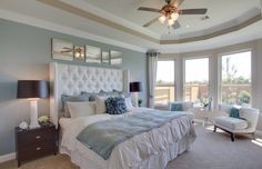 a bedroom with blue and white decor in it