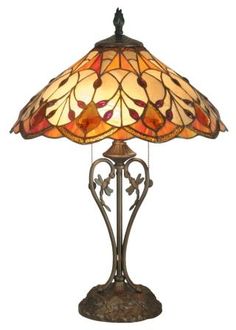 a lamp that is sitting on top of a table with a glass shade over it