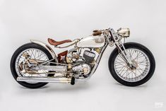 a silver and black motorcycle is shown on a white background in this image, it appears to be an old model