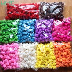 many different colors of crochet roses in plastic bags