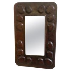 a mirror that is made out of wood and has circles on the frame, as well as