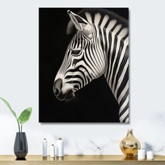 a black and white photo of a zebra's head on a wall above a table