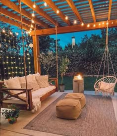 an outdoor living area with swings and lights