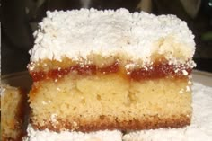 three pieces of cake sitting on top of a white plate covered in powdered sugar