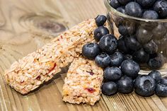 some blueberries and granola are on a table