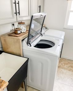 a washer and dryer sitting in a kitchen next to each other on top of a counter